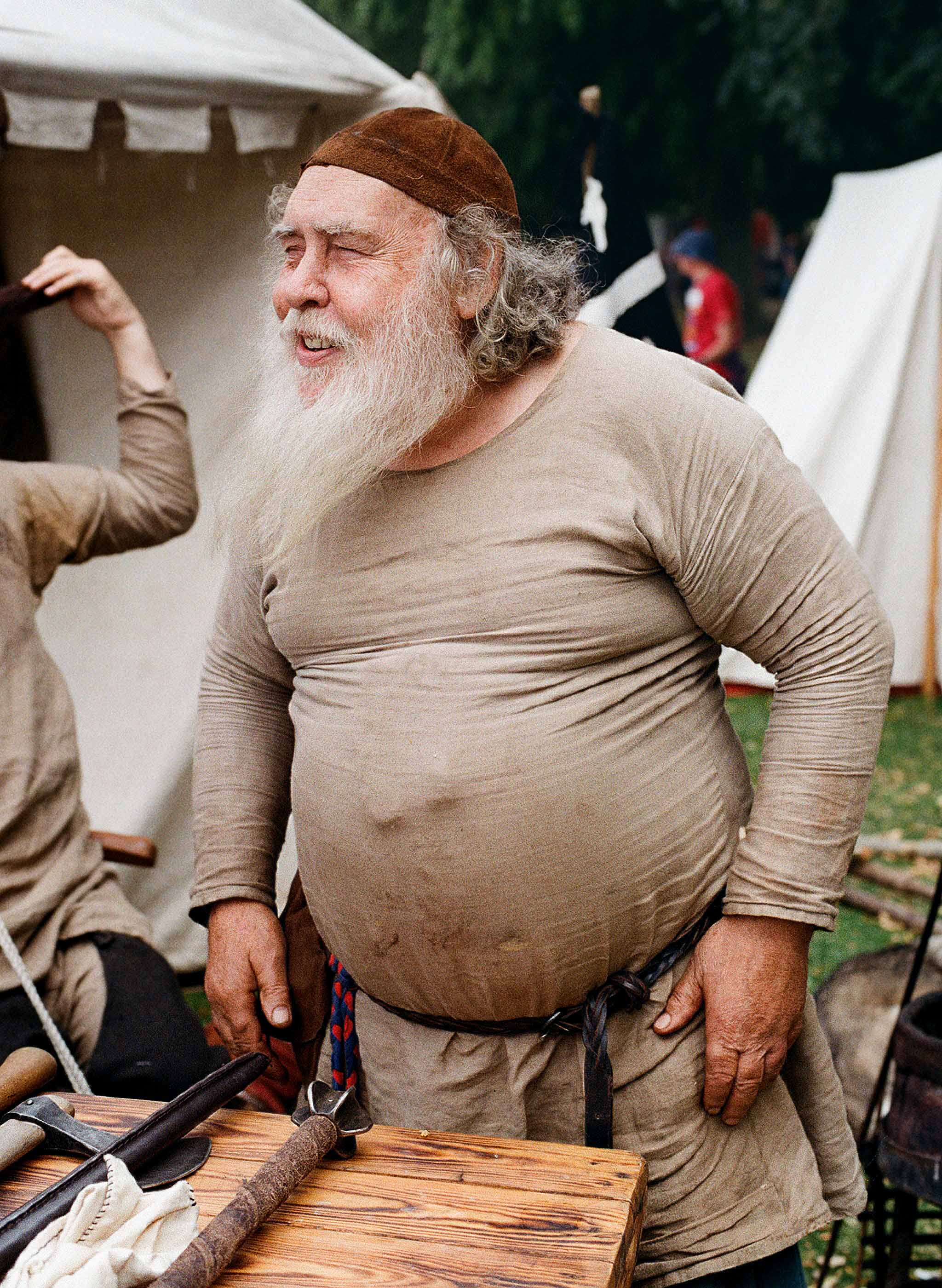 Chuckling old man with a big round belly