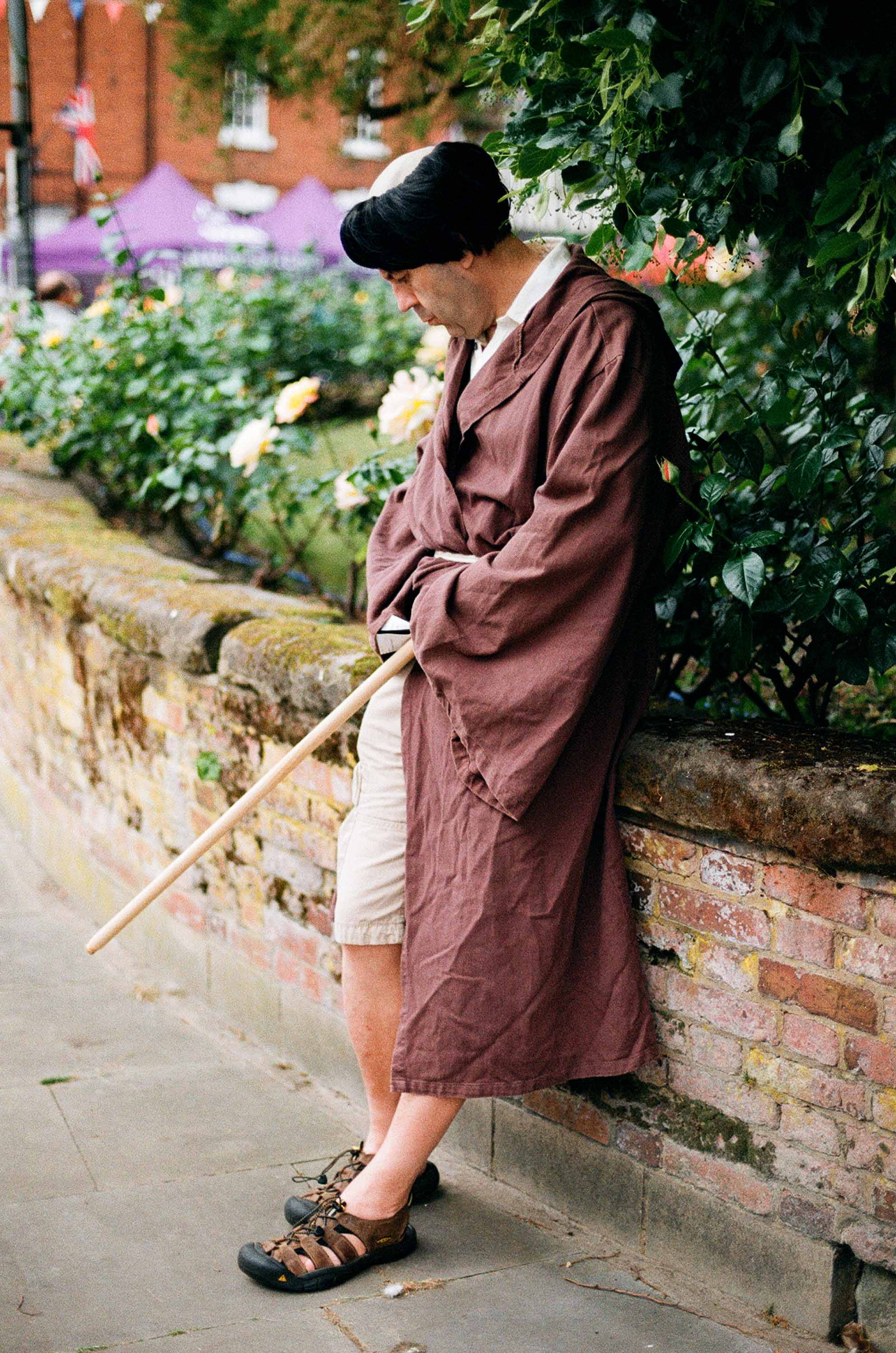 Monk leaning against wall