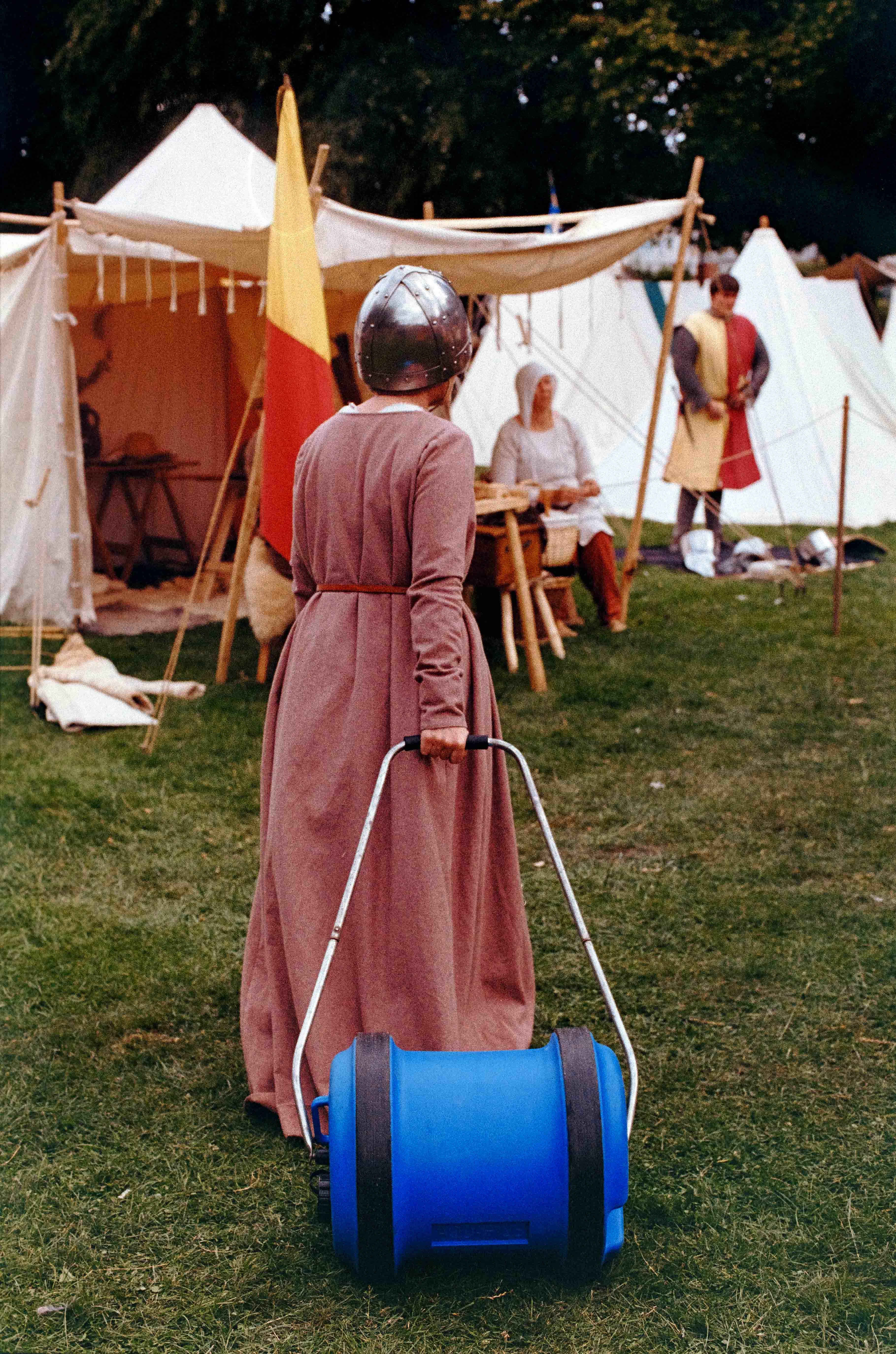 Lady in gown and nasal helm dragging inscrutable blue object